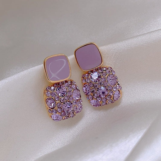 Boucles d'oreilles luxueuses violettes avec incrustation de zircone
