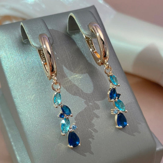 Boucles d'oreilles élégantes en cristal bleu et doré