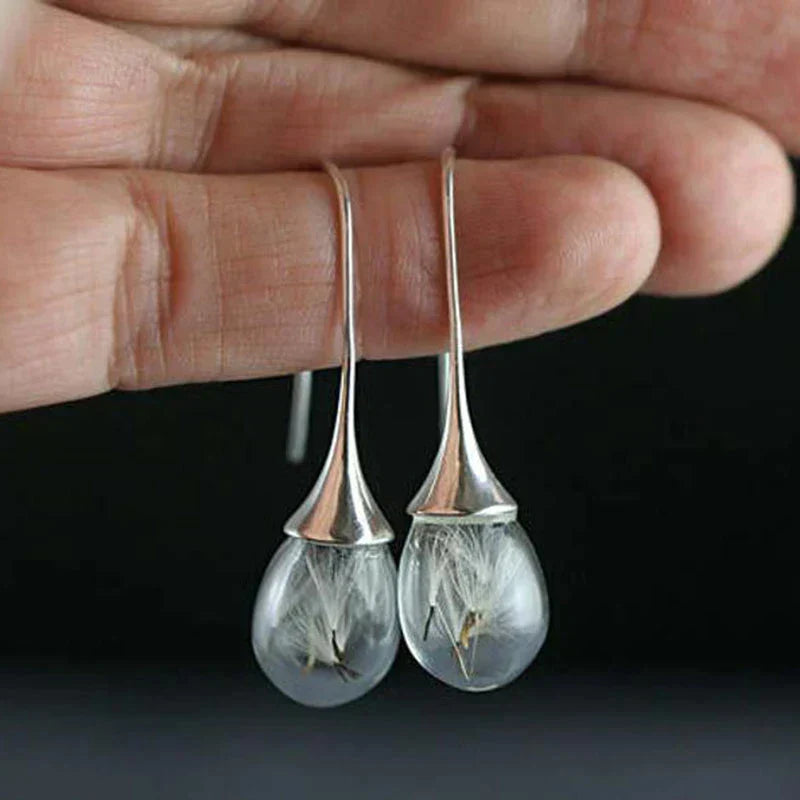Boucles d'oreilles avec pendentif en dent de lion argenté